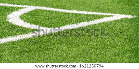 Green artificial grass turf soccer football field backgrond with white corner line boundary. Top view