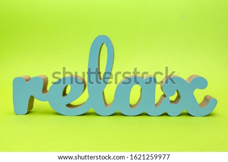 Wooden inscription relax on a green background