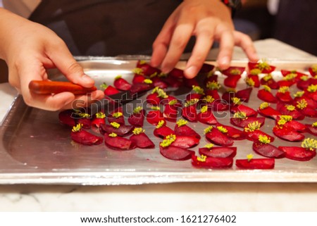Blurred. Professional Chef use bare hand to arrange decoration for luxury fine dining appetizer. Beautiful and modern concept style for Food Styling, creative plating and decorating presentation idea.