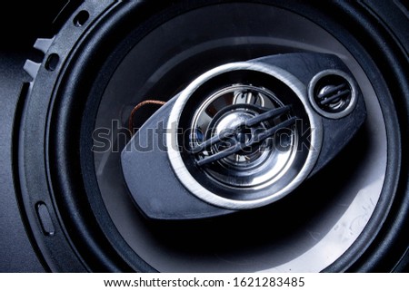 Modern car speaker close-up on a dark background