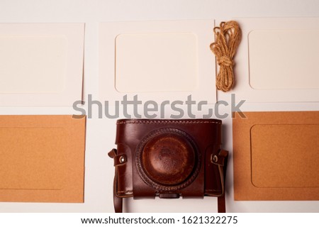 Storage and archiving of photos.Paper frames for photos, an old film camera in the case. Preserving your history. Photo Art.