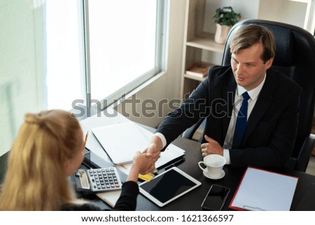 Business people shaking hands, finishing up a meeting or deal and sign contract together for making a business
