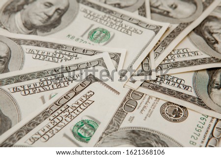 background from scattered dollar banknotes as abstract seamless. toned image.