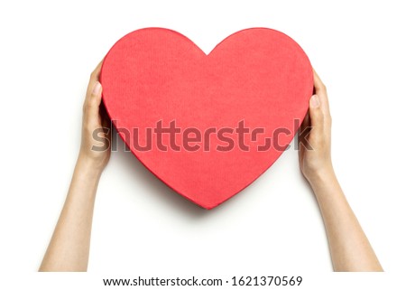 Woman hand hold a red heart gift box isolated on white.