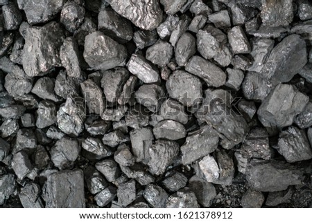 Char-coal. Pattern, heap. Pile of Bituminous carbon cinder. Stone coal Industry, business. Black coal mine close-up with soft focus. Anthracite coal bar. Royalty-Free Stock Photo #1621378912
