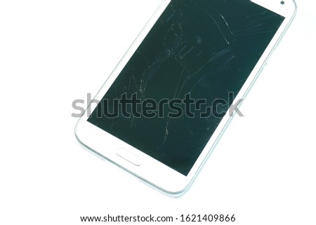 A smartphone with a broken screen on a white background