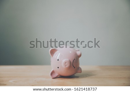 Piggy bank on wood table. Financial investment and save money concept Royalty-Free Stock Photo #1621418737