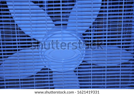 A blue fan blowing cool air
