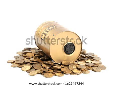 a decorative oil barrel stands on a pile of Russian metal coins