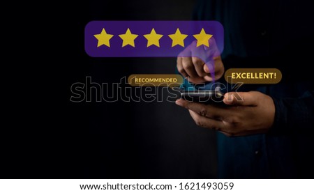 Customer Experiences Concept. a Modern Man Giving Five Stars Rating and Positive Review via Smartphone. Client's Satisfaction Surveys on Mobile Phone. Front View