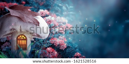 Magical fantasy elf or gnome mushroom house with window in enchanted fairy tale forest, fabulous fairytale blooming rose flower garden and fire flies on mysterious blue background, moon rays in night