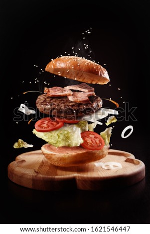 burger levitation on black background