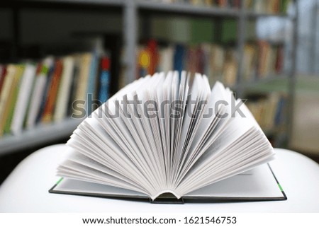 Open book on the table in public library