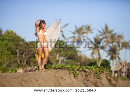young girl with surfboard at  beach