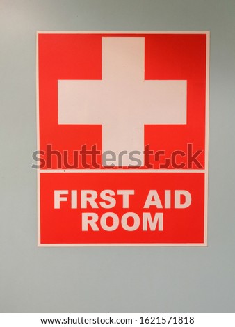 First Aid Room symbol with a gray wall background