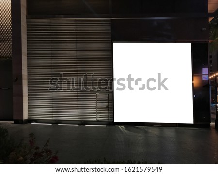 Big light box billboard poster ad space beside a modern outdoor wall. Huge digital signage copy space for sales, marketing and video wall display mock up