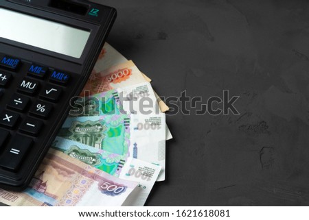 Close up photo of stack of Russian money rubles with calculator