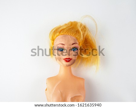 Weird Freaky Toy Doll Parts on White Background. Dirty face. Abandoned toys Royalty-Free Stock Photo #1621635940