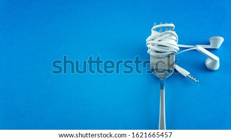 Headphone UTP cable wrapped on fork like spaghetti a music addict concept