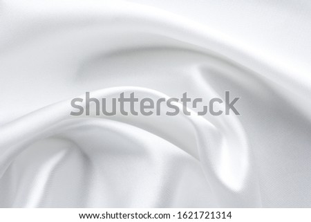 white satin fabric with large folds, textile background