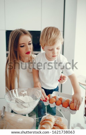 Family in a kitchen. Beautiful mother with little son