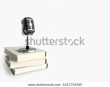 Retro microphone stand on books. Podcast and audio book concept on light gray background.
