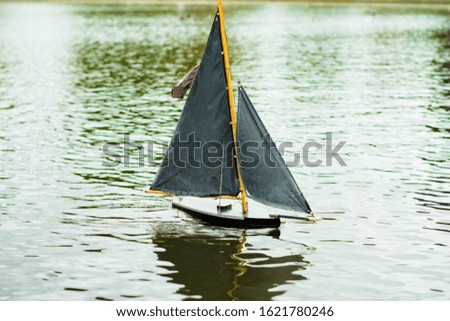 Pond with Small toy Sail on water