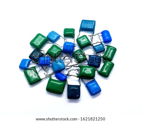 Blue and green capacitors on the white background. Usable for websites, banners, flyers, catalog. Photo of isolated electronic components for semiconductor
