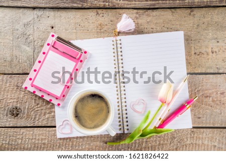 Coffee mug for breakfast, empty notebook, pencil and tulip flowers on table top view flat lay style. Good morning concept Copy space