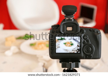 Tasty pasta on display of professional photo camera in studio