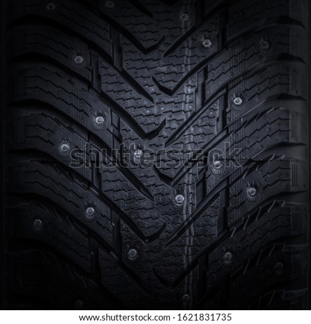 car tire with studs macro, fragment, blurred backgroundd Royalty-Free Stock Photo #1621831735