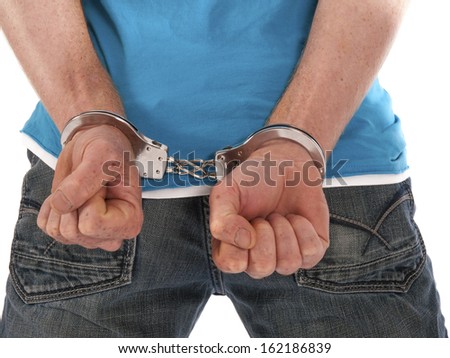 man with handcuffs on his back Royalty-Free Stock Photo #162186839