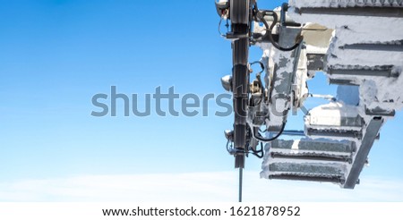 Close-up shot of a mechanism to pull a steel rope on a cable car, and behind it is clear blue skies. Copy Space.