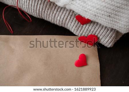 Red hearts are scattered on knitted sweaters.concept for valentines day
