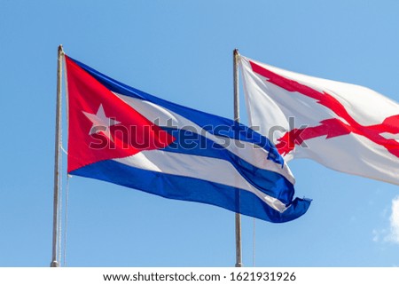 Cuban flag waving against blue sky