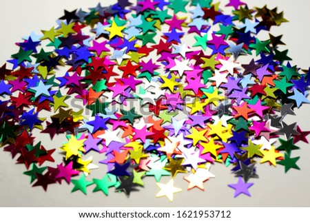 Holiday background with little colorful stars. Macro, Close Up