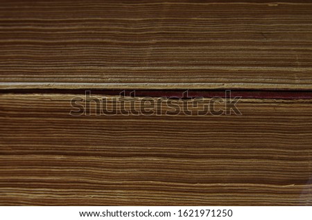 texture of yellowed pages of old books.  stack of closed old books side view