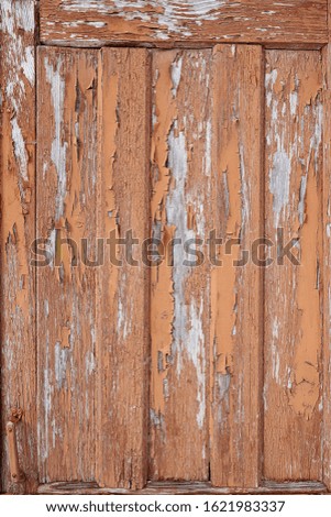 Old wooden shed boards with peeling paint. vertical direction of the boards. texture with blue tones
