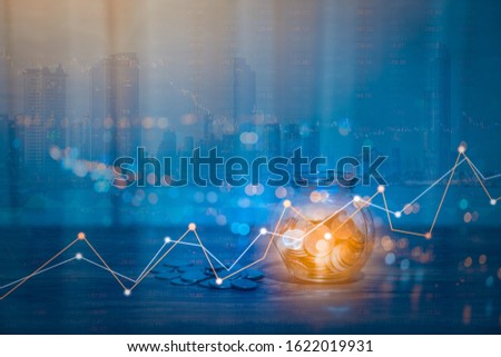 Double exposure of Money coin stack growing graph with bokeh light background,investment concept. plant growing on coin, business finance and save money concept.