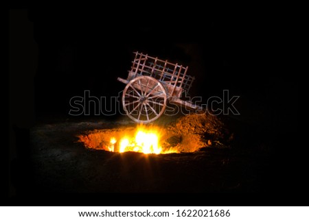 Vintage wagon or cart and campfire at night, folk or western ambience, art lightpainting