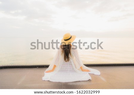 Portrait beautiful young asian women happy smile relax around sea beach ocean at sunrise or sunset time