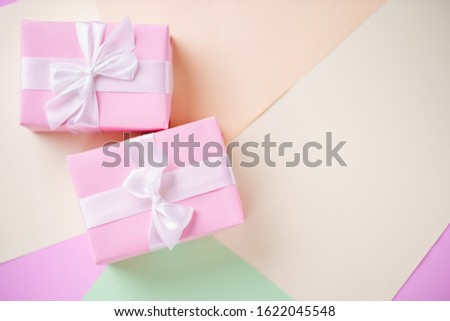 Creative background, holiday present. Handmade paper gift boxes on multicolored backdrop. Valentine's, Mother's or Women's Day background. Copy space