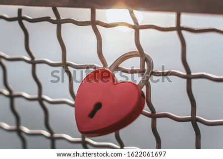 Red heart with keyhole. Metal lock Valentines day background. Concept of love, romantic relationship and fidelity. Copy space for your text
