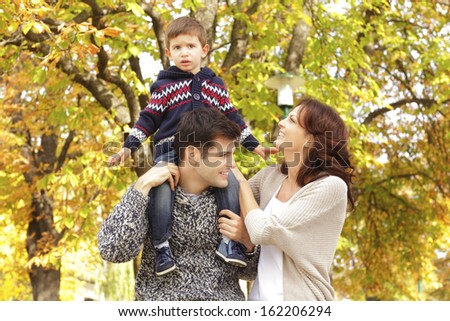 Loving family standing in the park. Shallow focus.