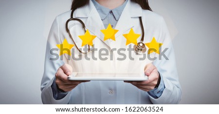 Medical Services Rating. Unrecognizable Female Doctor Holding Digital Tablet With Five Stars Icons Above, Light Studio Background, Panorama, Crop