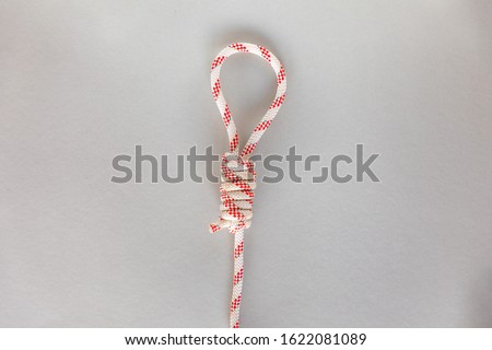 Hangman's ship knot on grey background, boating knot