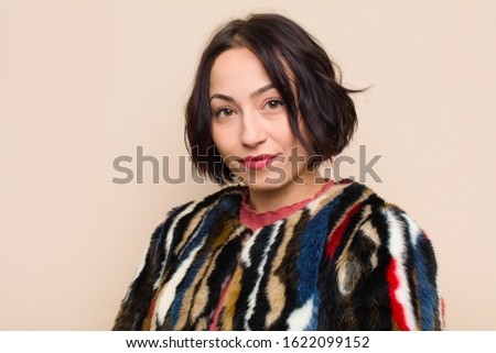 young pretty woman against beige background