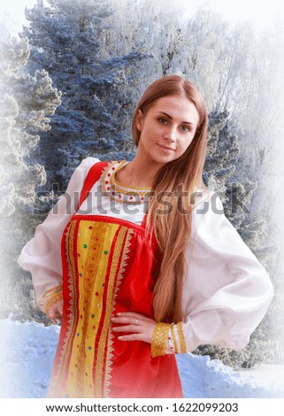 a young Russian girl in national dress on the background of the winter forest