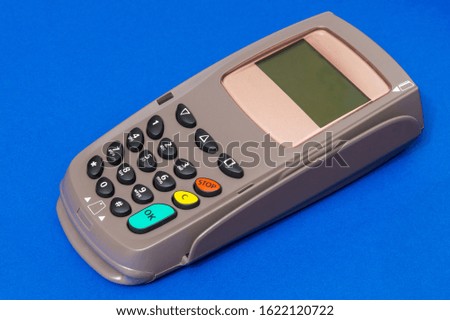 Payment terminal for receiving money on isolated blue background top view
