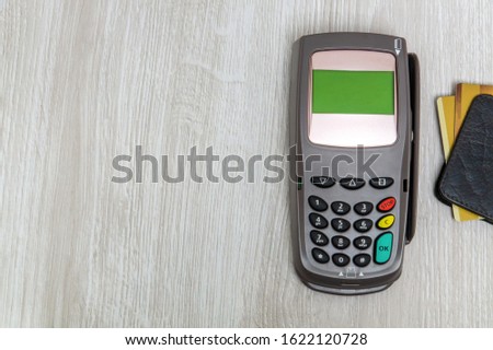 Payment terminal with card for receiving money on office desk top view